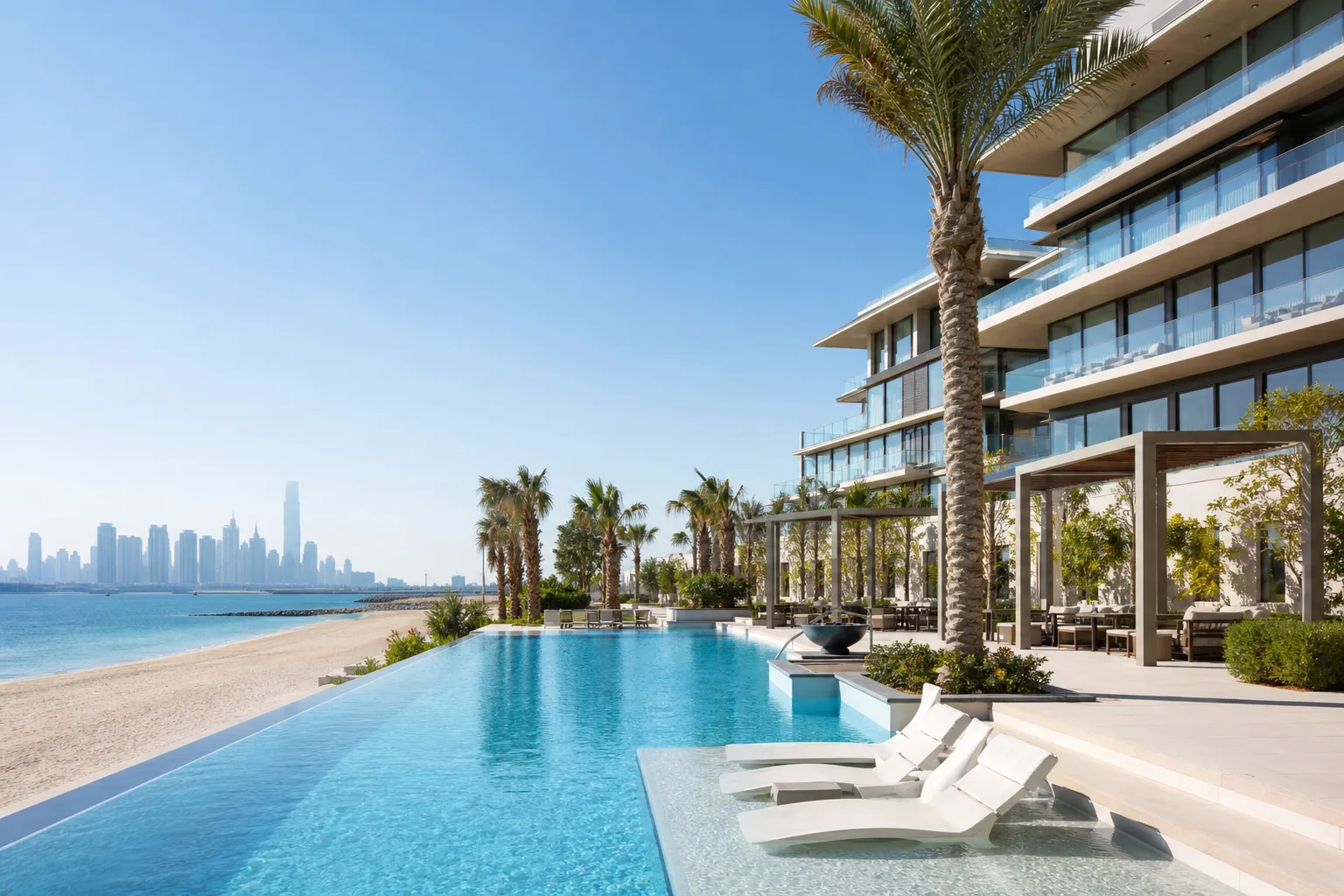 High-end new-build residence with infinity pool, palm trees and a contemporary façade facing the beach