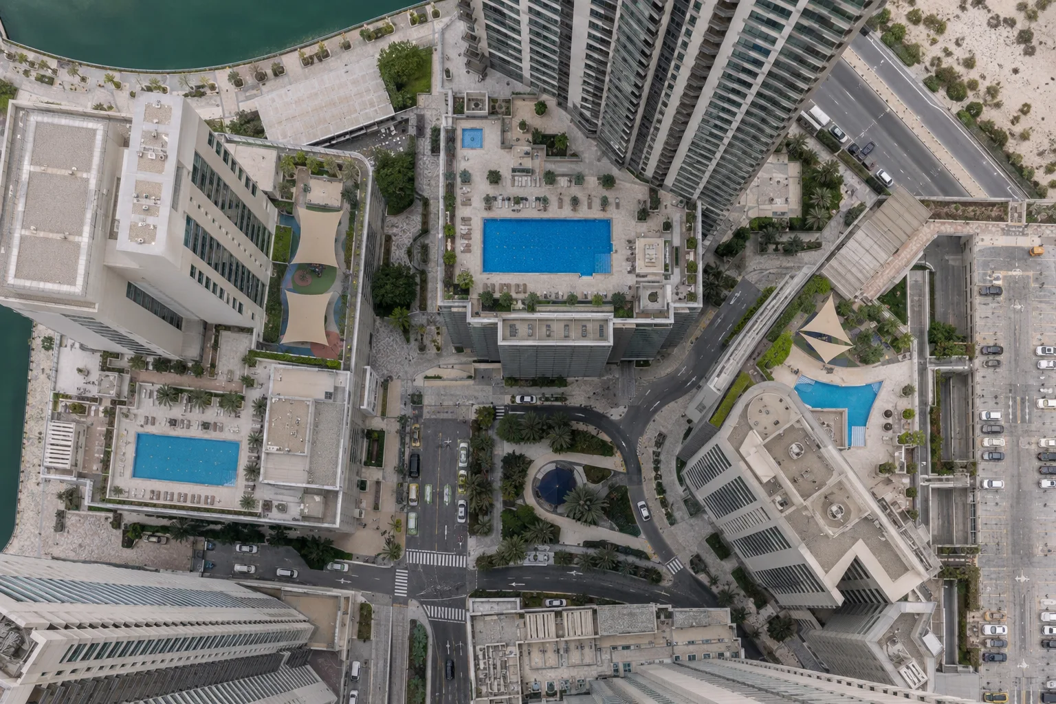 Overhead view of residential podiums with pools and car parks on Reem Island