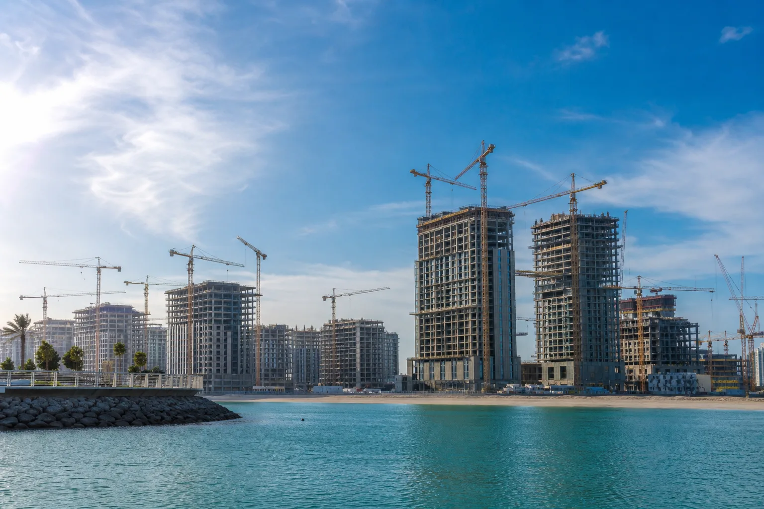 Construction sites of new coastal residences with cranes on a developing Dubai waterfront