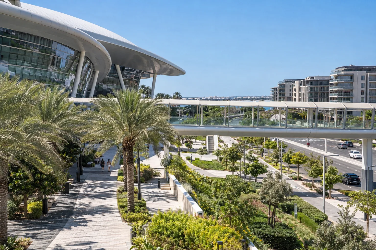 Shaded walkway and landscaped boulevard linking a large leisure complex to Yas residential neighbourhoods