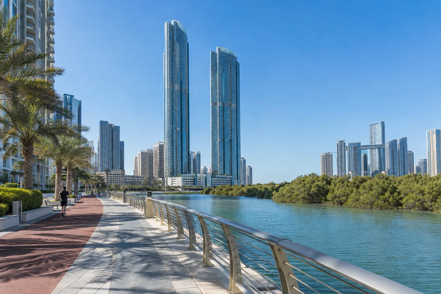 Glass residential towers completed in the early 2010s, seen from the Reem Island promenade at midday