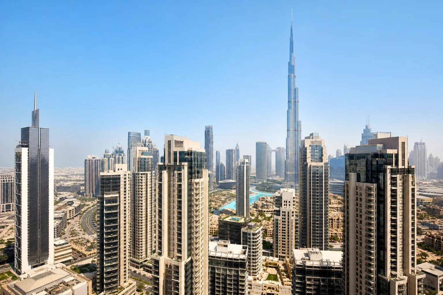Elevated view of Downtown Dubai residential towers with the Burj Khalifa in the background under a clear sky