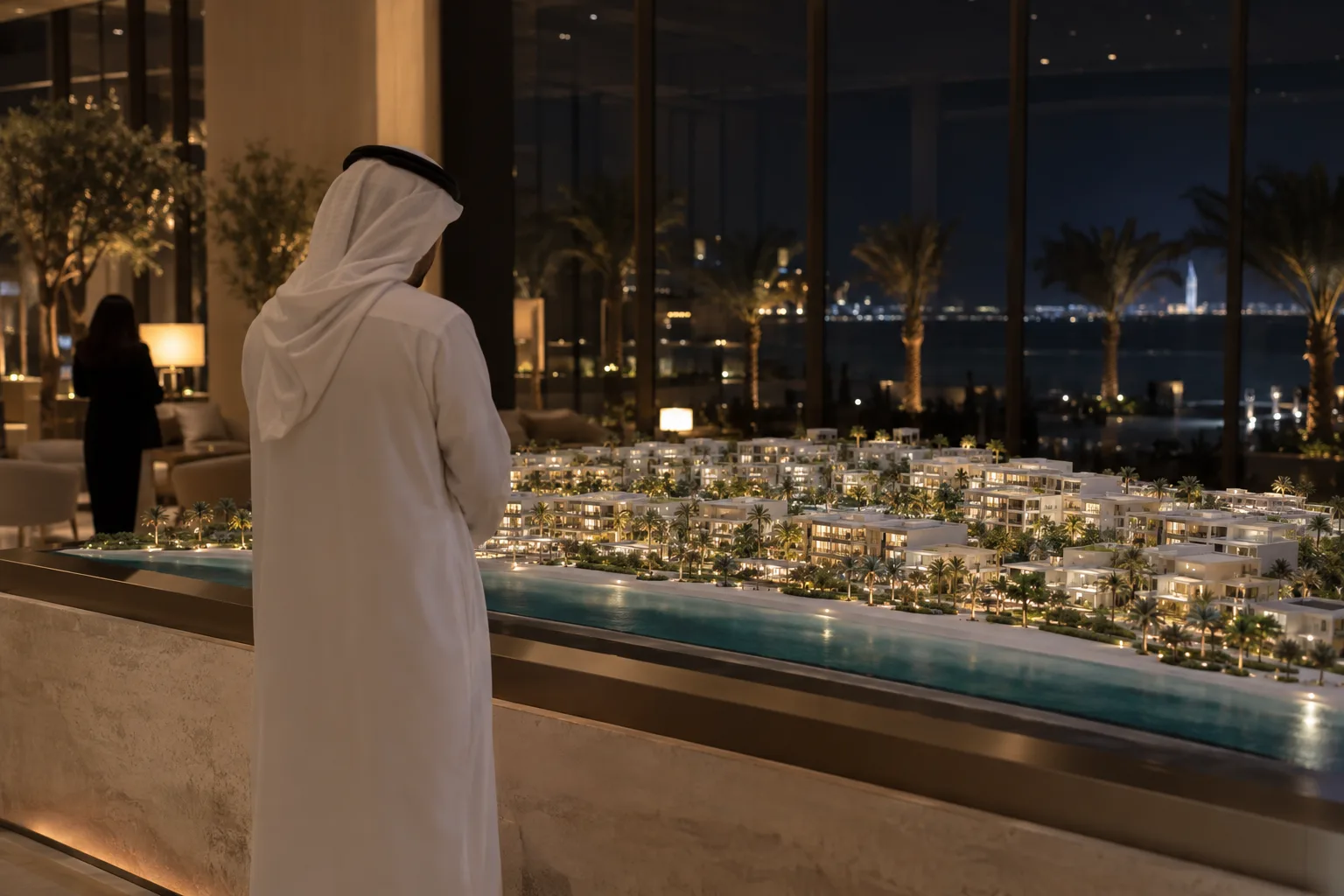 Investor seen from behind in front of a residential project model in a sales gallery in Saadiyat, at night