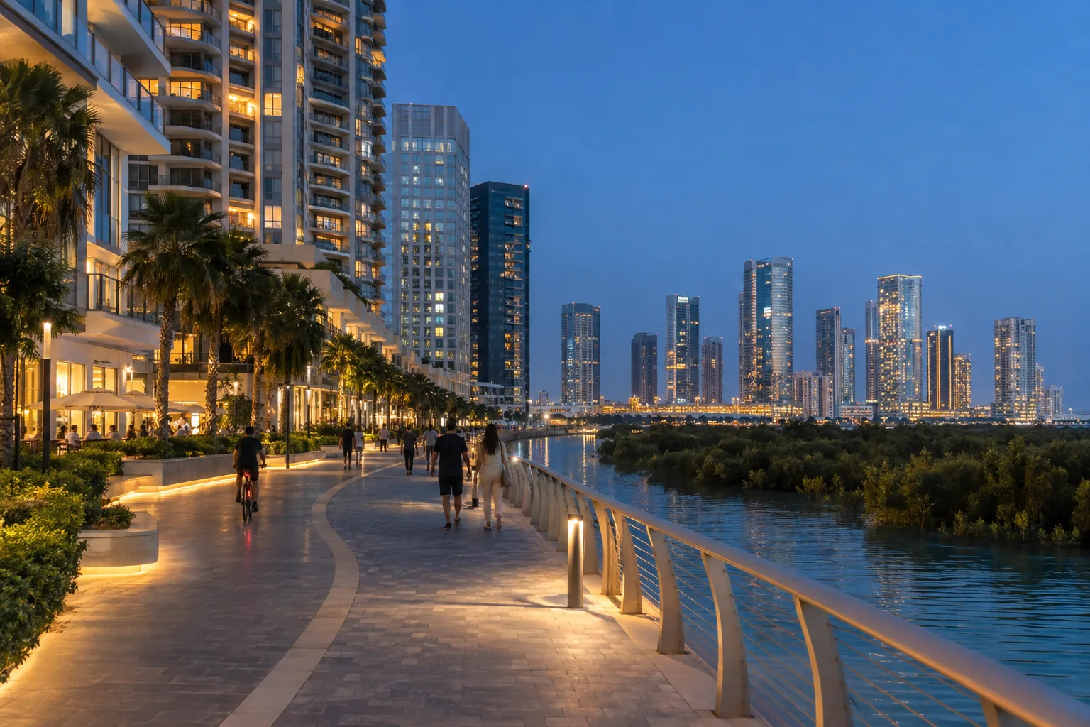 Waterfront promenade on Reem Island at blue hour, with distant passers-by at the foot of residential towers